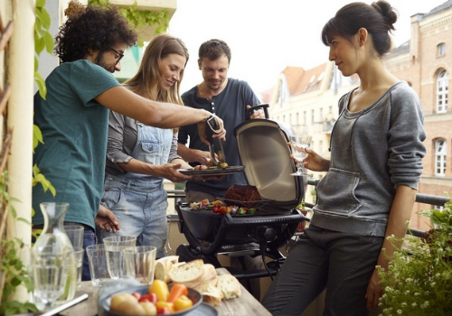 barbecue électrique sur balcon en centre ville avec un groupe d'ami